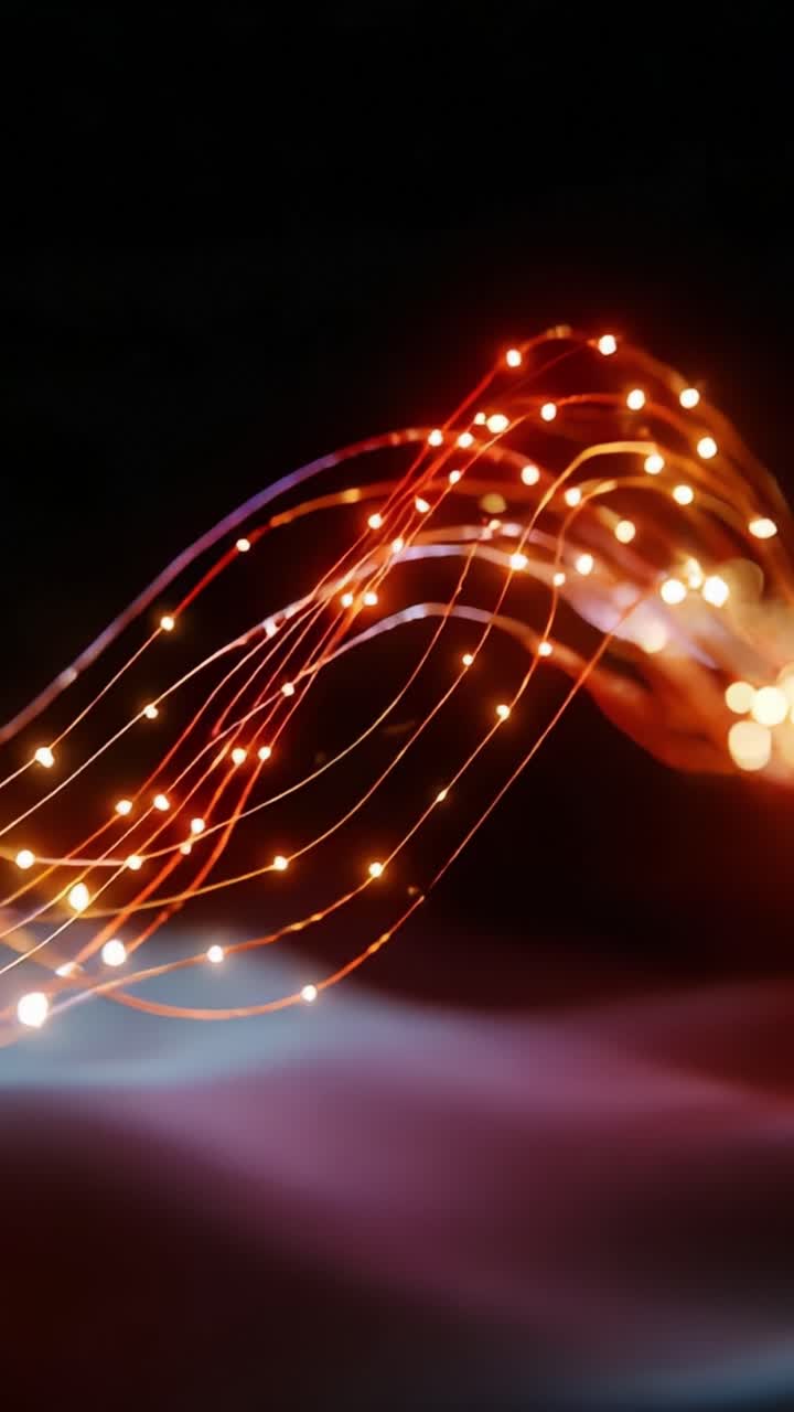 An ethereal display of luminescent strands woven in vibrant colors of red and orange, dancing gracefully against a dark backdrop, illuminating the scene with a mesmerizing interplay of light and shadow