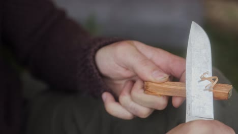 making a feathered stick with a sharp bushcraft knife - tinder to start a fire