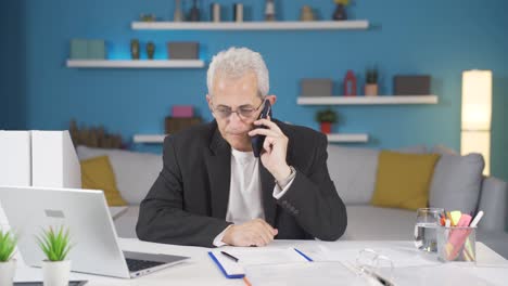 home office worker man getting bad news on the phone.