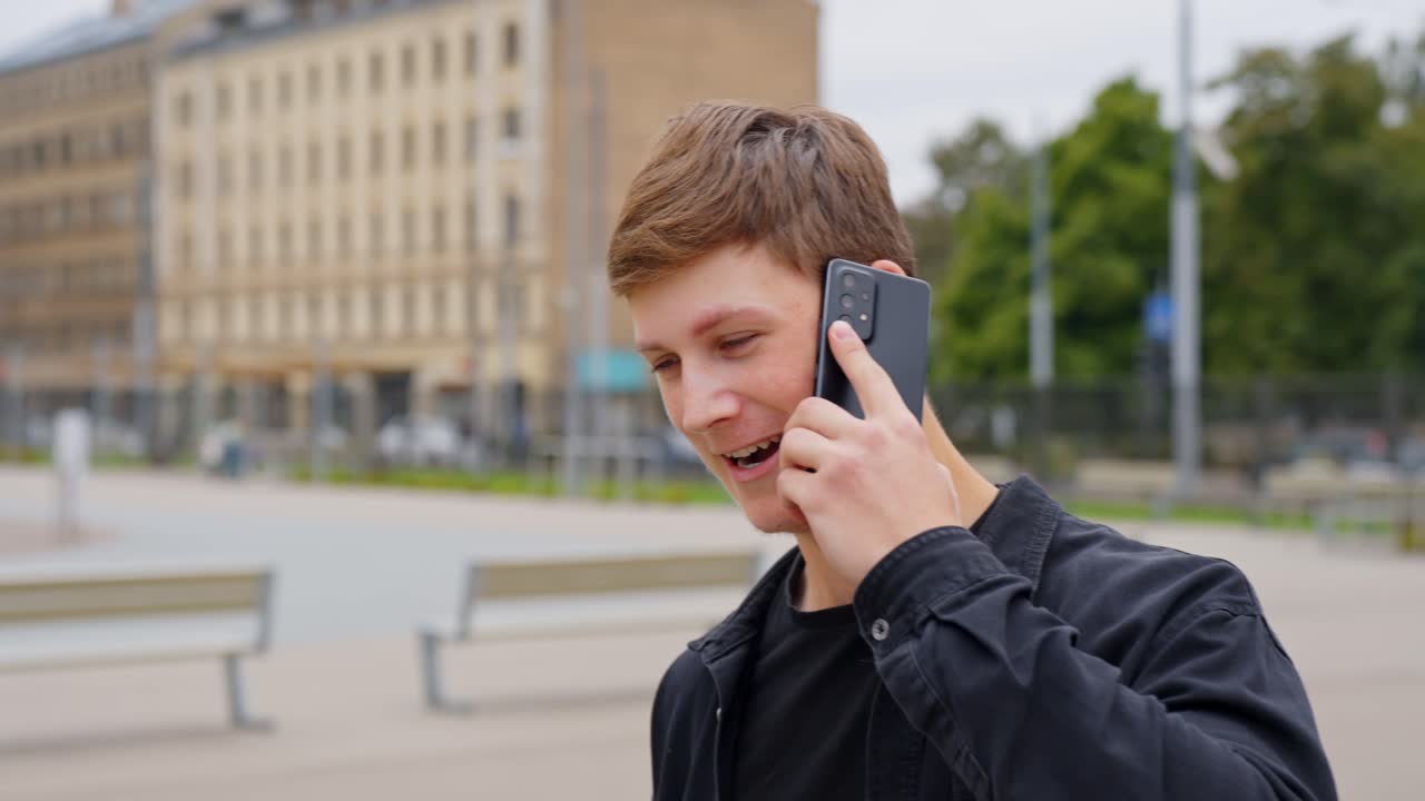 Lifestyle shot of a young adult making an important phone call on the street