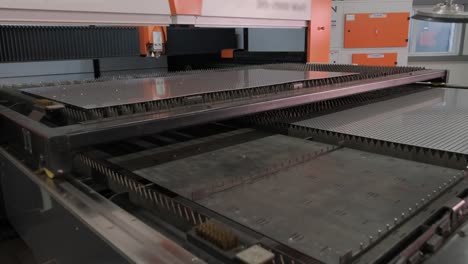 large sheet of stainless steel slides out of the metal laser cutting machine