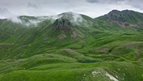 dense overcast over mountains and green hills