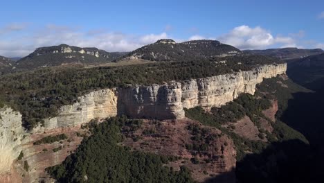 Aerial-of-Tavertet-Cliffs-with-mountain-landscape-in-background,-zooming-shot