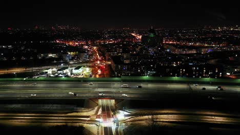 Top-down-night-city-roads-with-cars-driving-aerial-view