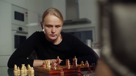 mother and son enjoying a game of chess together