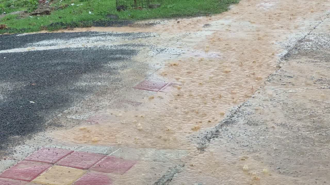 Closeup of heavy rain on the concrete road and pavement, Heavy rain on a concrete road and pavement can lead to several issues, including surface damage, reduced friction, and potential flooding,