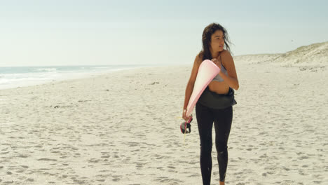 Female-surfer-with-surfboard-running-on-the-beach-4K-4k