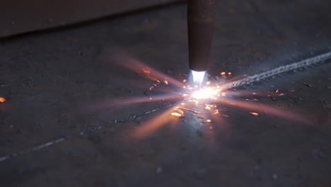 plasma cutter close up - cutting metal with high energy through heat and electrical power - special tools in the metal industry - high resolution 4k shot in slow motion - close up