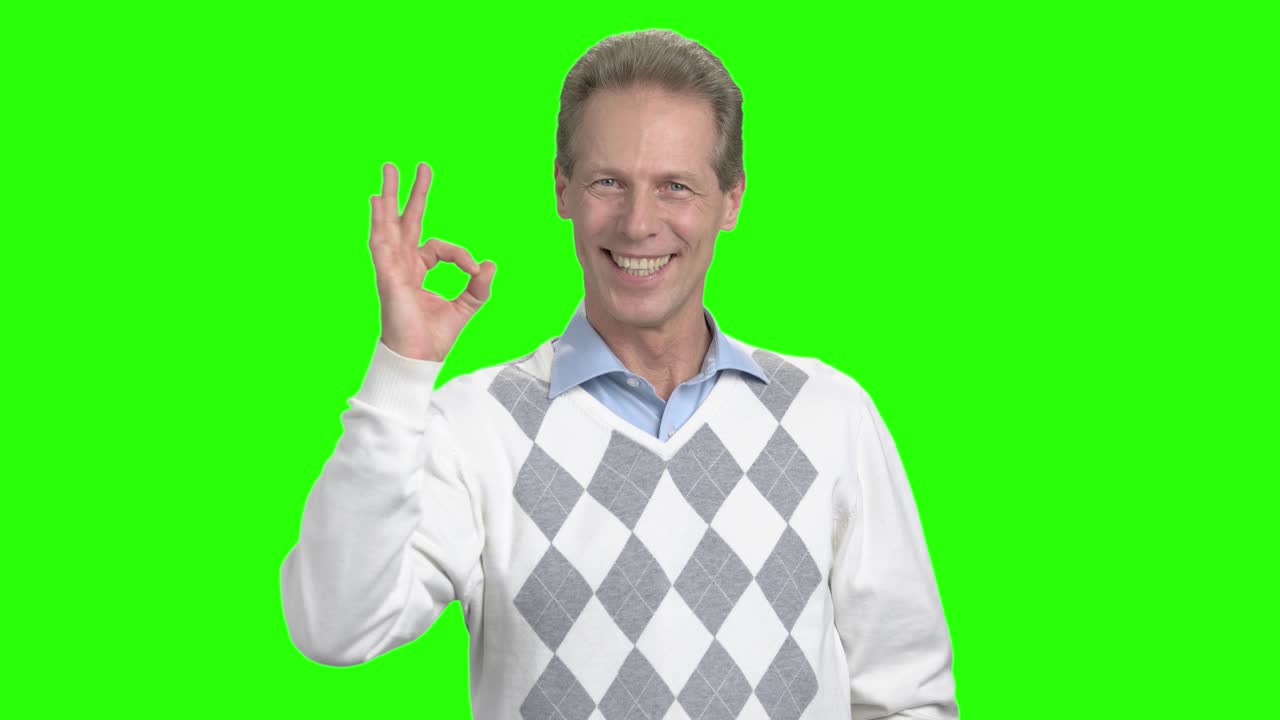 Mature man showing ok sign.