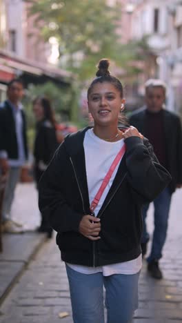 young woman walking in city street