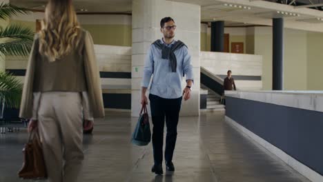 business people walking through airport terminal