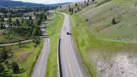 on a summer day, a truck passes through the beautiful green landscape in british columbia