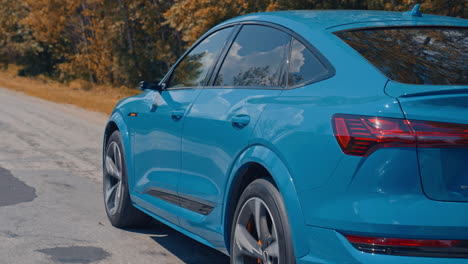 audi e-trone alone on road. close up of the rear of blue audi e-tron