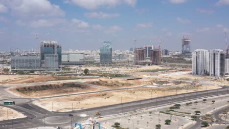 cityscape under construction with skyscrapers and cranes