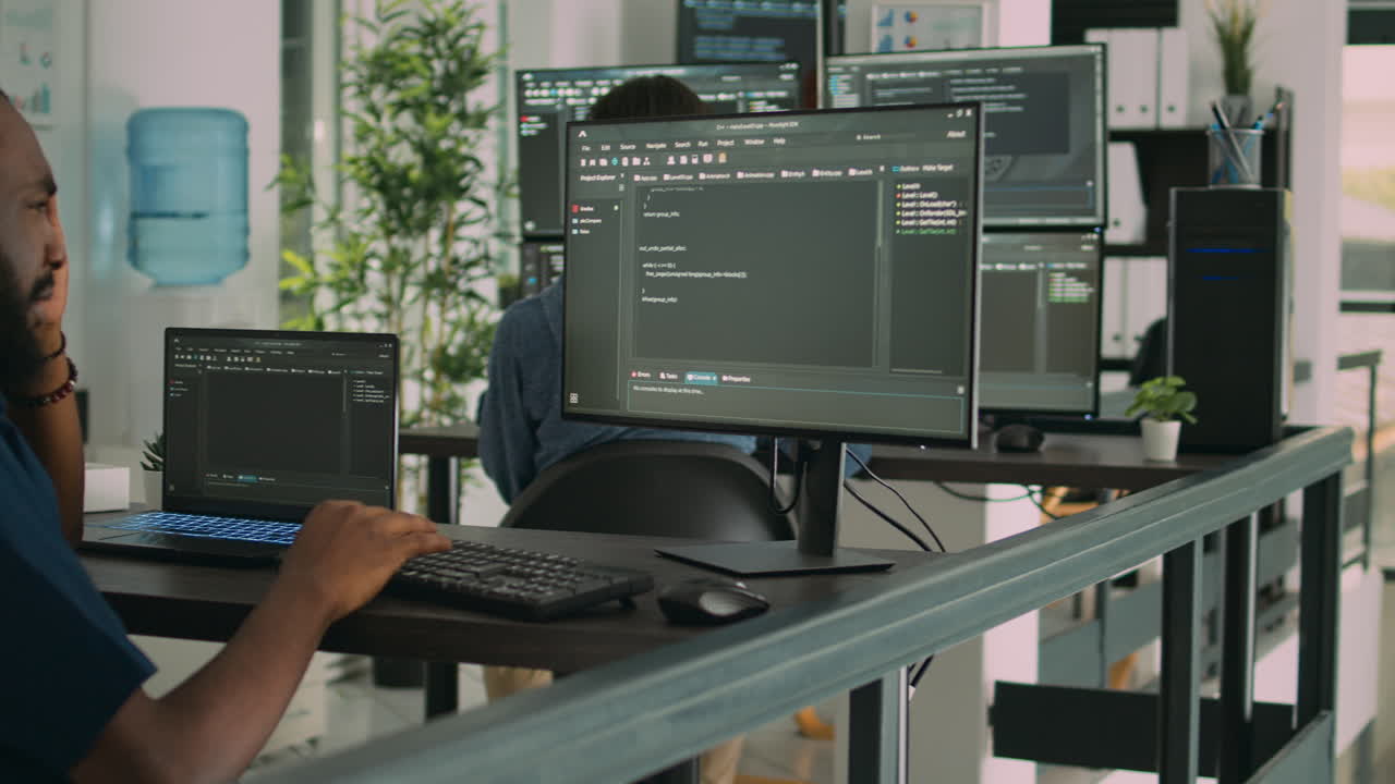 African american coder writing programming language on computer