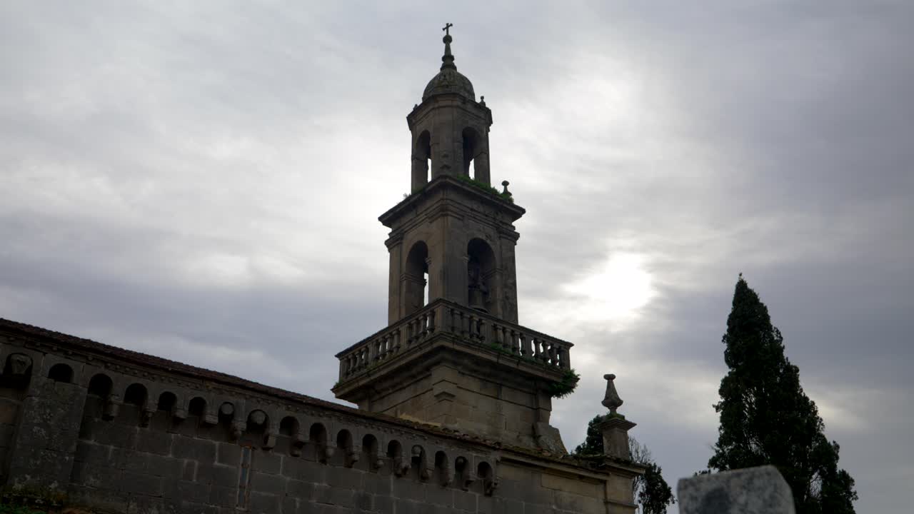 Ancient Church Bell Tower under a Cloudy Sky