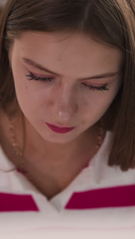 woman works at table in college library closeup. serious lady reads publication and books at desk in hall of literature storage. student learns lesson