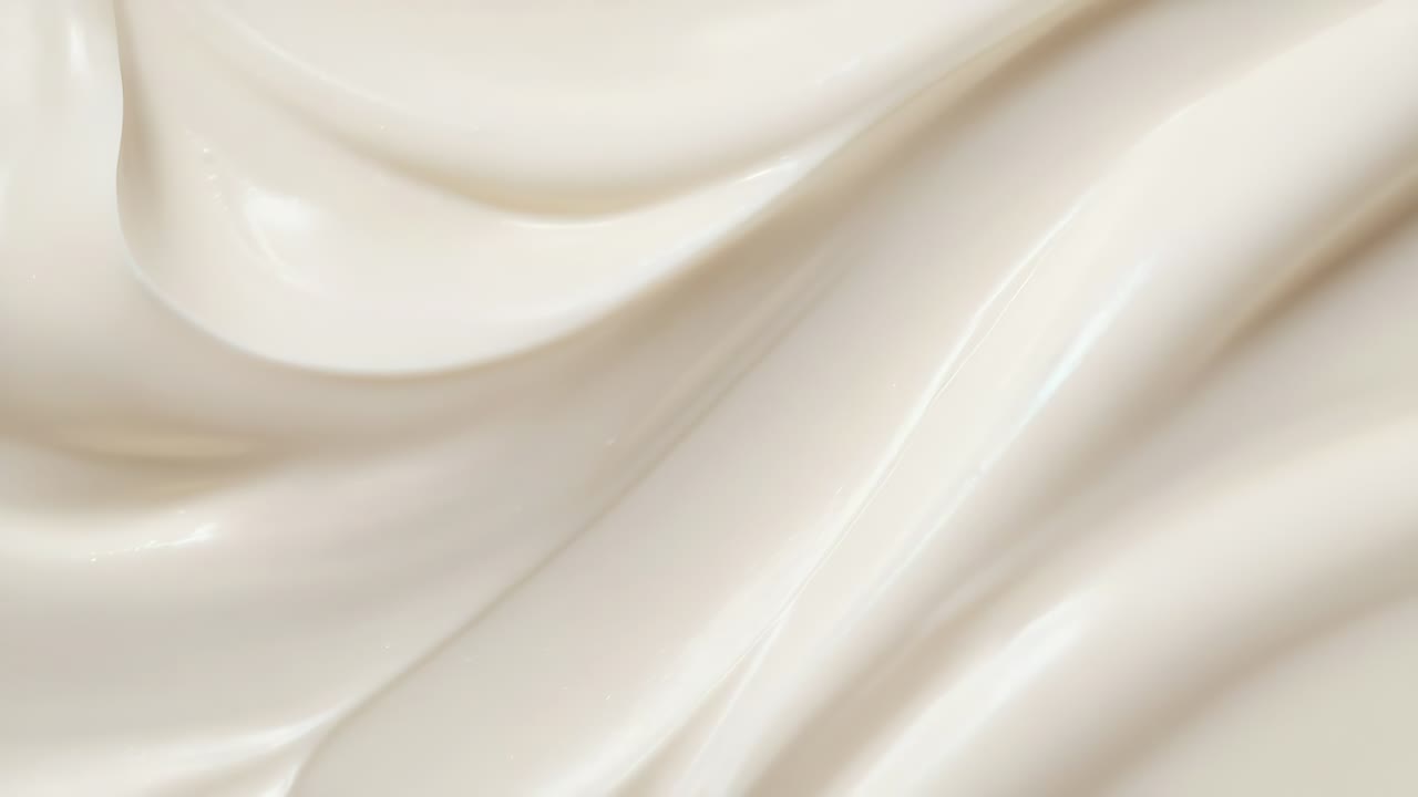 Close-up shot of smooth, creamy texture with flowing curves, ideal for a skincare or beauty product
