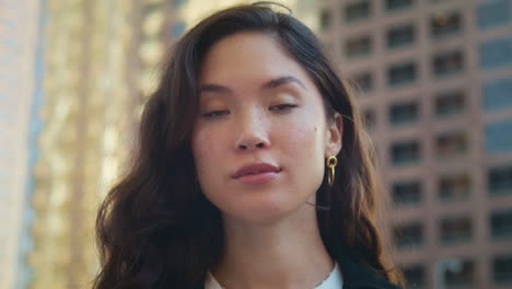 gorgeous woman looking camera on street closeup. portrait of asian businesswoman