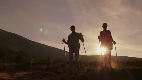 Romance-Of-An-Active-Way-Of-Life-A-Couple-Of-Tourists-In-The-Rays-Of-The-Setting-Sun-Go-Along-The-Mo