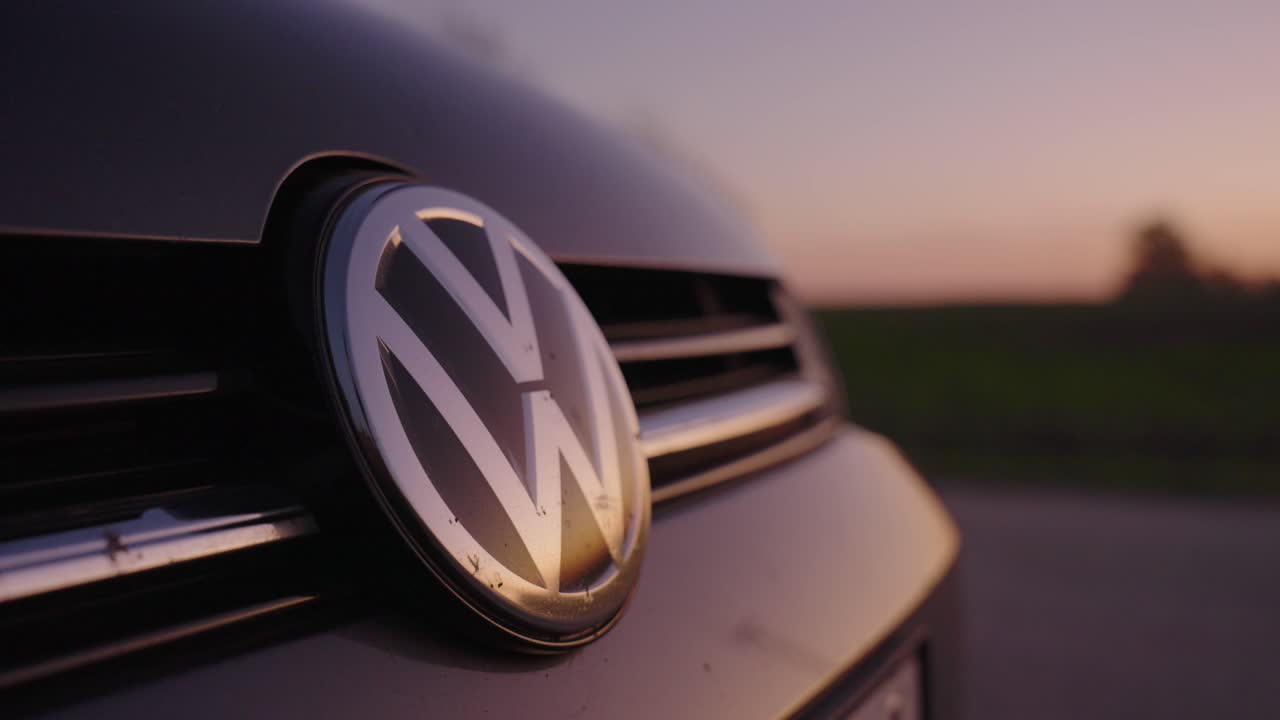Volkswagen logo sign on the car at sunset. Volkswagen Golf Cinematic Shot at sunset. Close up view, global automobile manufacture, car dealer and manufacturer. VW Golf 7. Volkwagen Golf VII.