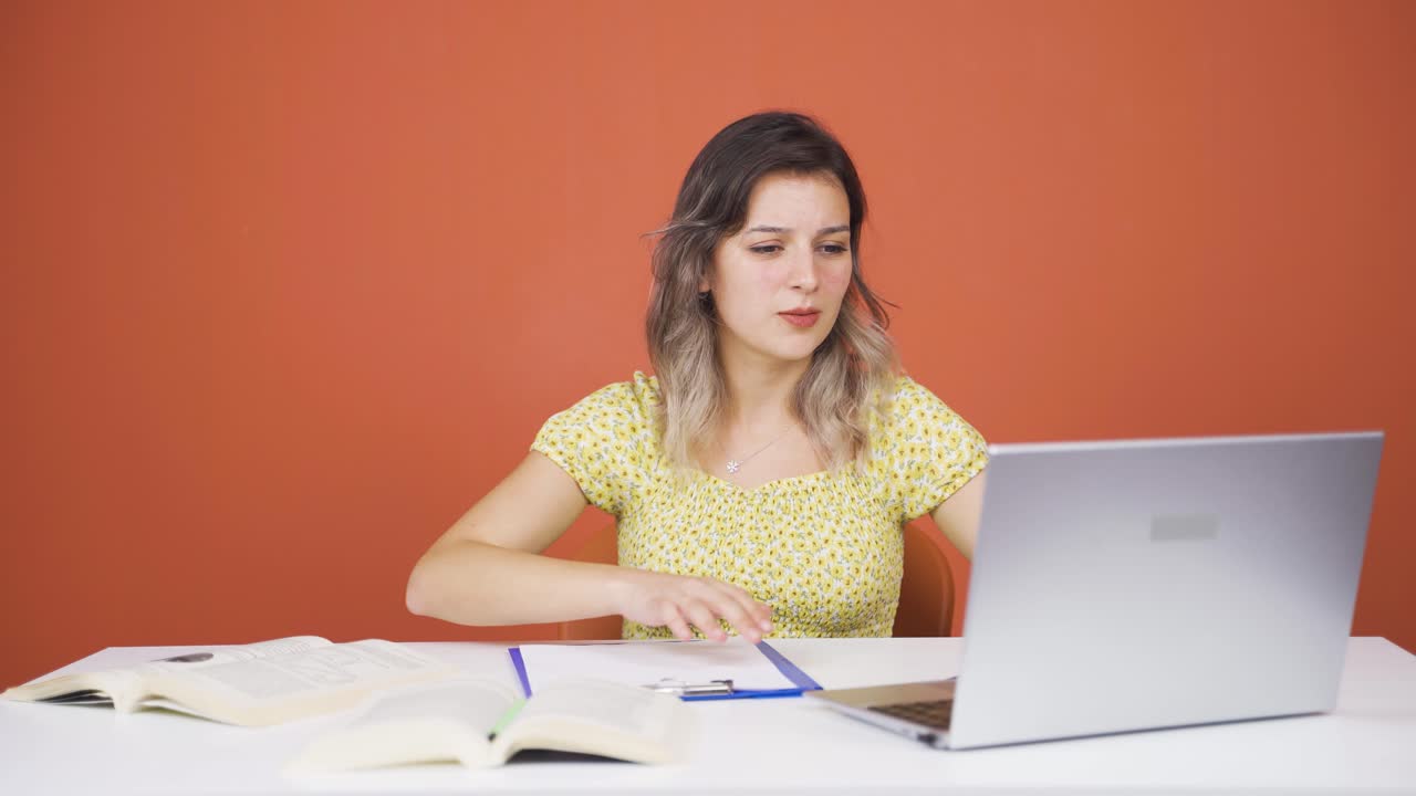 Young woman sending wrong mail on laptop. Can't get mail back.