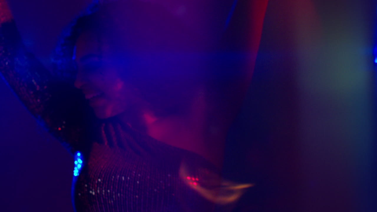 Close Up Of Young Woman In Nightclub Bar Or Disco Dancing With Sparkling Lights