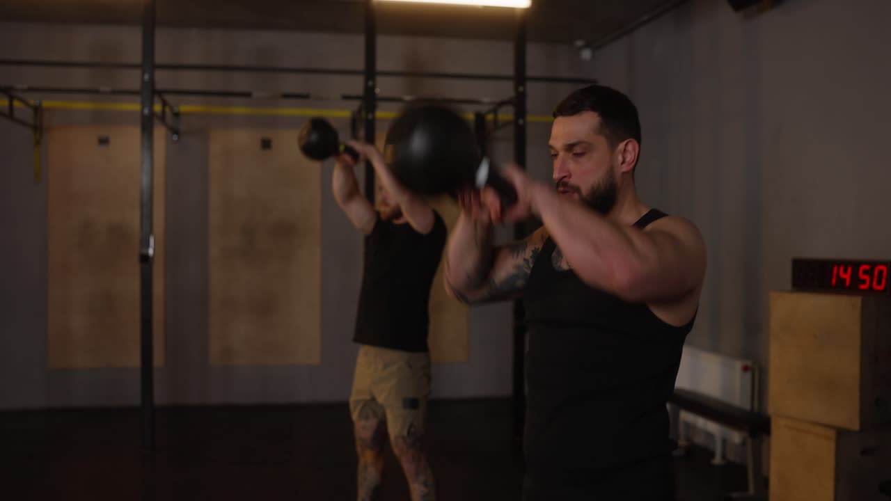 Men exercising with kettlebells in a gym