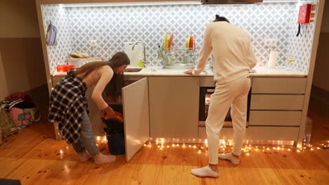 couple cleaning a kitchen