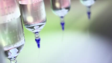 Close-up-of-rotating-medical-grade-syringes,-they-are-hanging-upside-down-and-moving-in-circle-shape