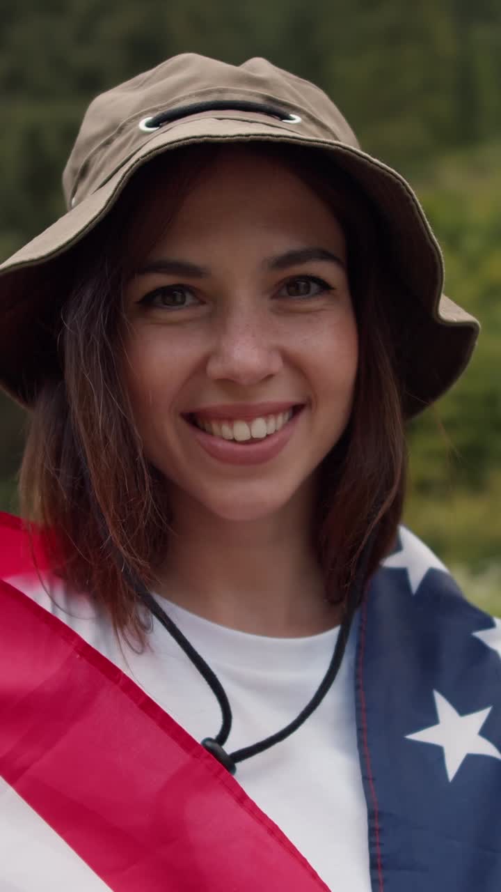 Happy Woman with American Flag in Nature