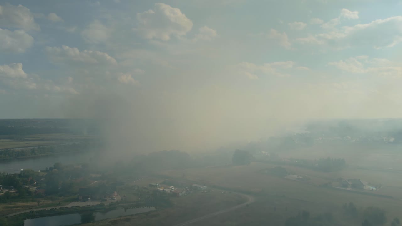 Smoke and haze from wildfire spreading over rural landscape near the Odra River in Szczecin, Poland