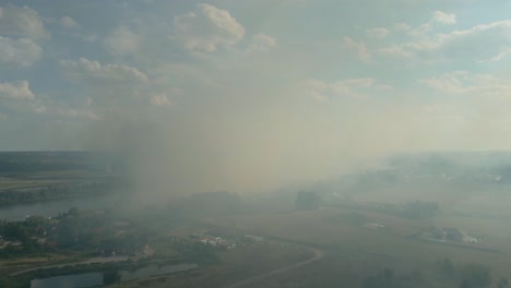 smoke and haze from wildfire spreading over rural landscape near the odra river in szczecin, poland