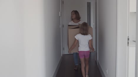 mom and daughter carrying cartoon box