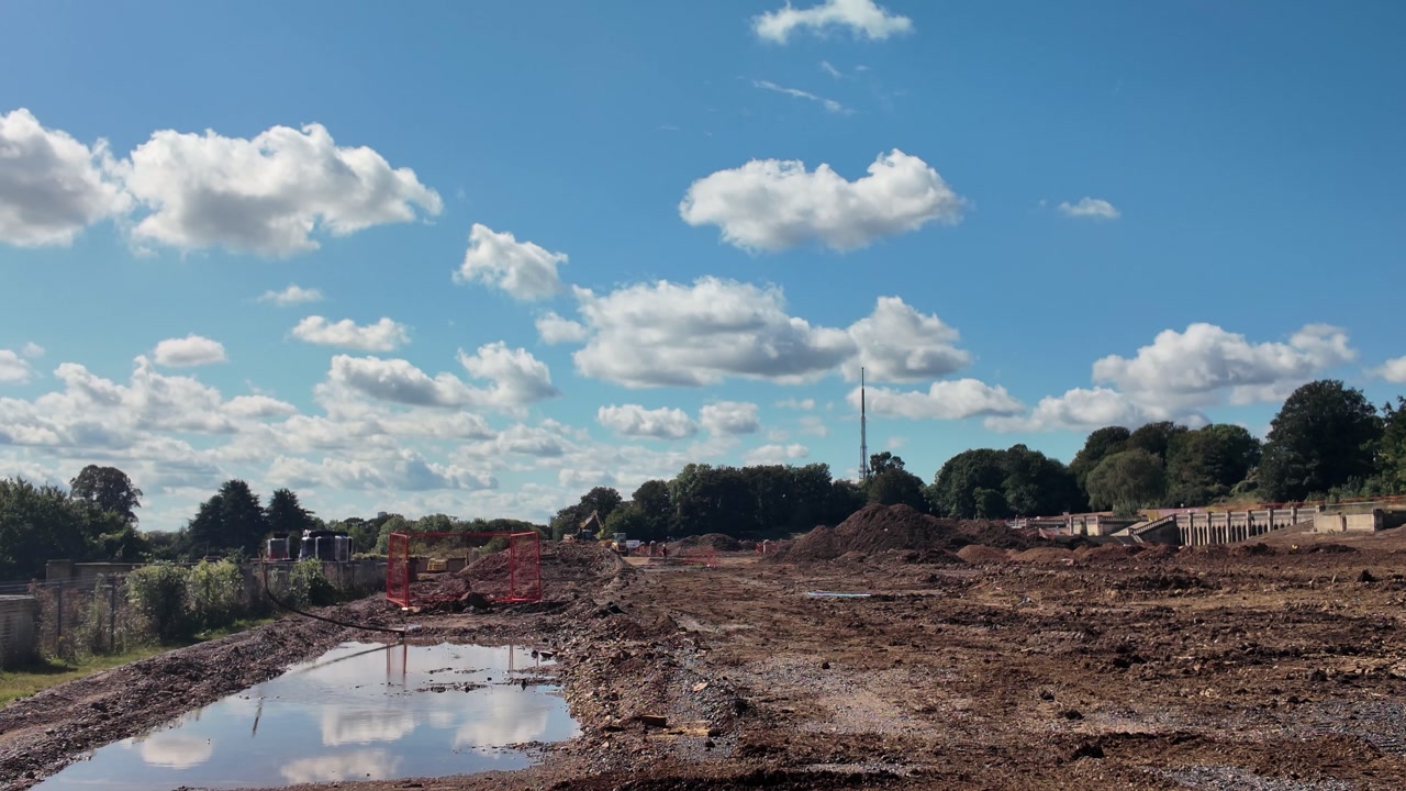 Regeneration works taking place at Crystal Palace Park in London, featuring mud, puddles, and construction equipment