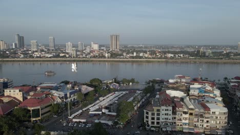 aerial rotates down tonle sap river in city of phnom penh, cambodia