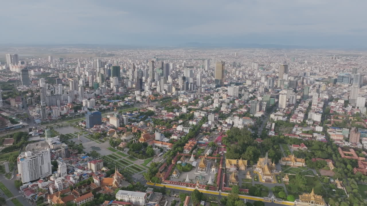 Aerial video of Phnom Penh shows the Royal Palace near the river, surrounded by gardens and golden rooftops
