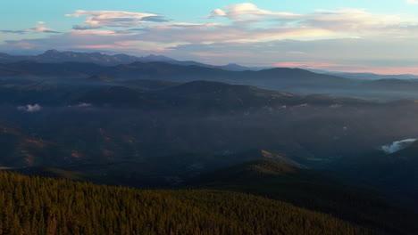 cinematic aerial drone sunrise morning fog lifting denver front range foothills rocky mountains layers i70 idaho springs evergreen mount evans 14er wilderness squaw pass echo mountain circling right