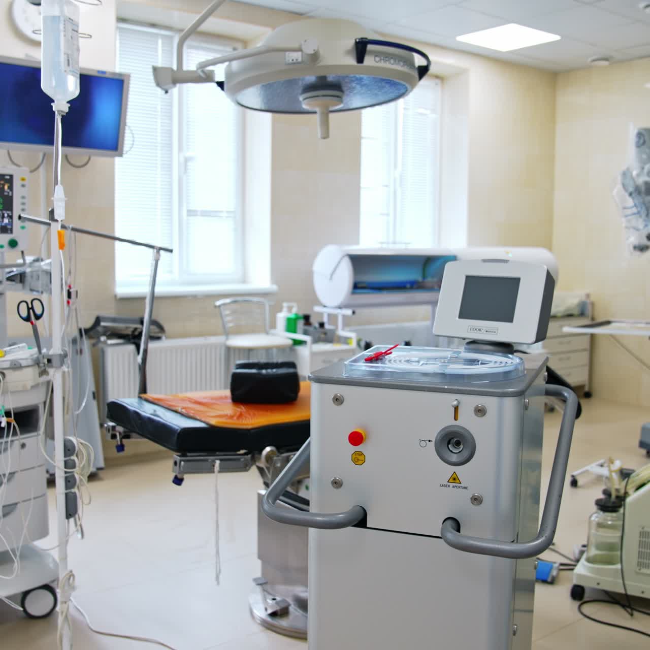 Lots of advanced equipment in modern surgery room. Empty operational theatre with Da Vinci robot at backdrop