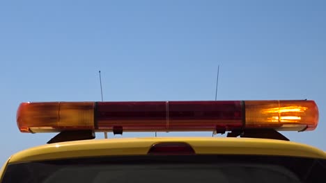 an airport marshaller car showing a bright stop sign with flashing orange lights