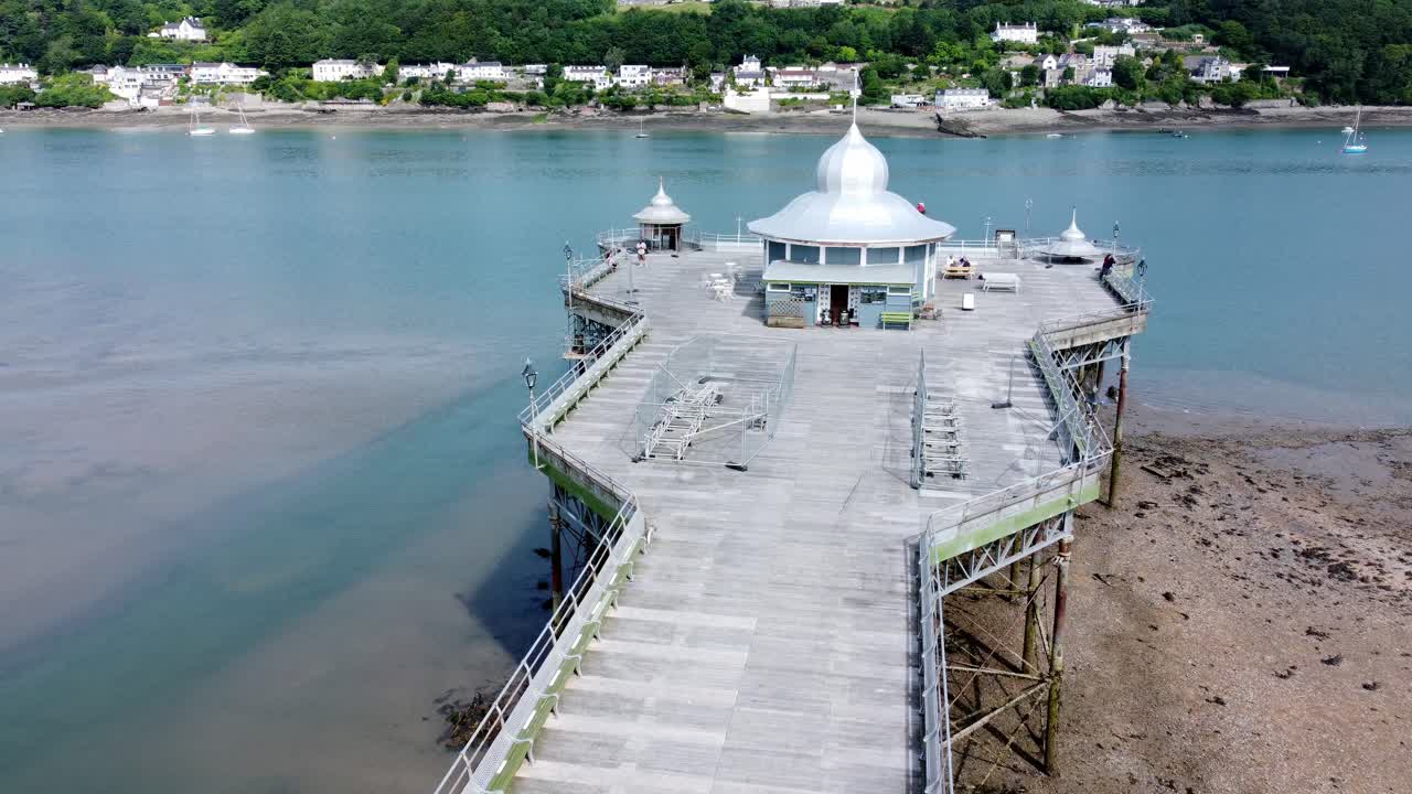 Bangor seaside pier North Wales silver spire pavilion low tide aerial view close over boardwalk