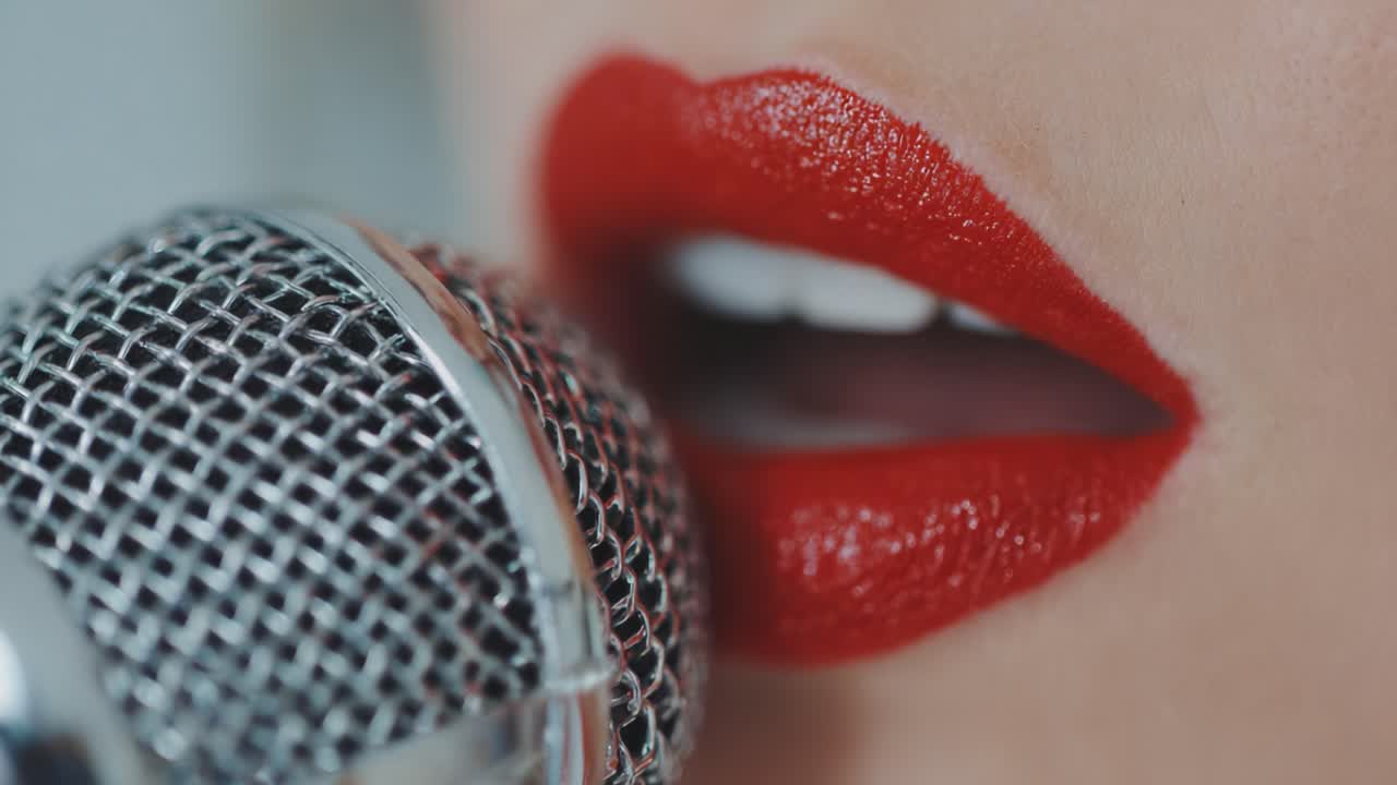 Close-Up Shot of Red-Lipped Singer Holding a Microphone, Capturing the Intensity and Passion of Performance in Vibrant Detail and Expression