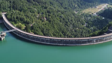 aerial orbit hyperlapse shot of a dam creating a beautiful turquoise lake paltinu of doftana valley in romania