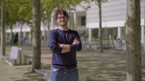 Happy-handsome-man-standing-outdoor-and-looking-at-camera