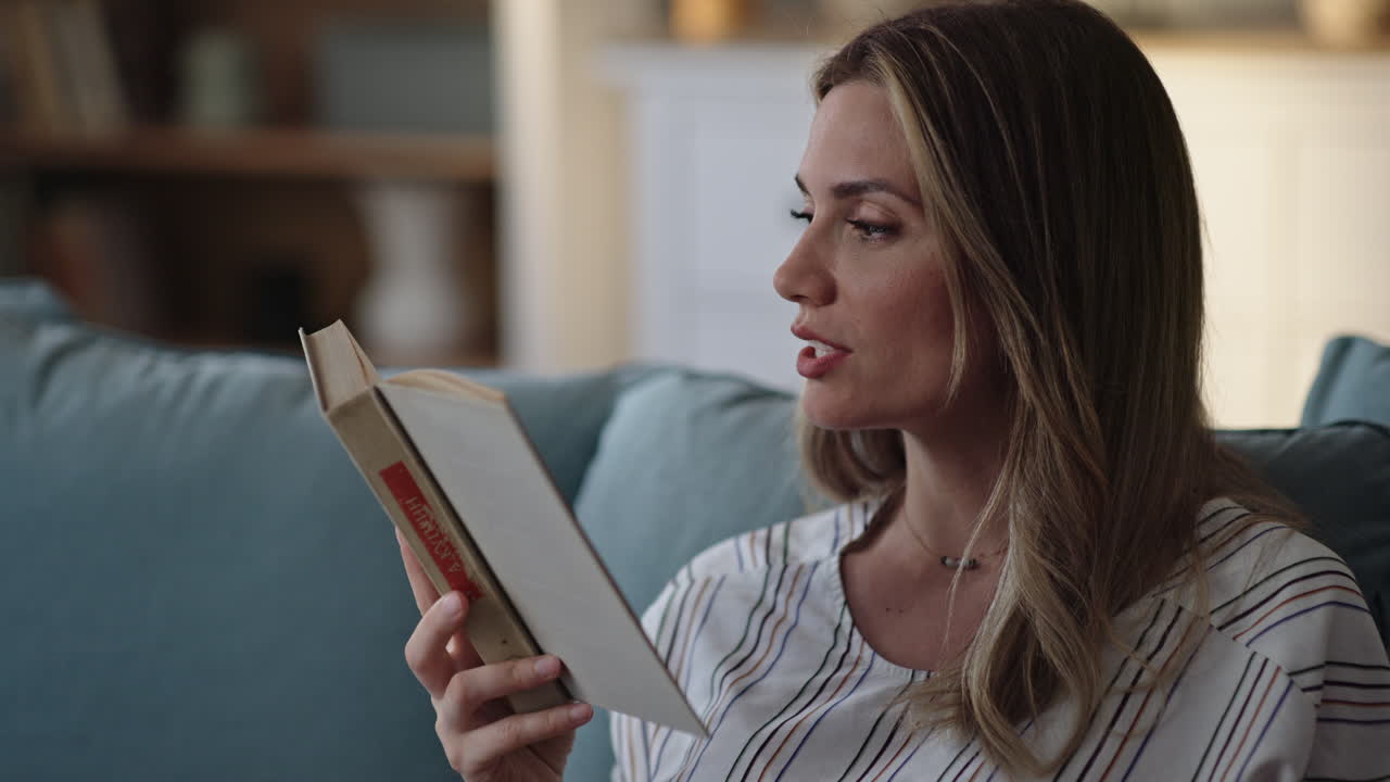 Woman Reading a Book on Couch