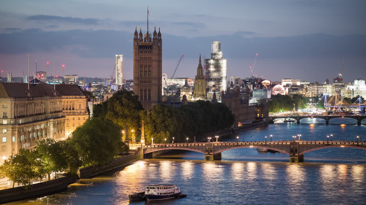 Blue hour timelapse of traffic on bridges and river Thames outside the Palace of Westminster in London