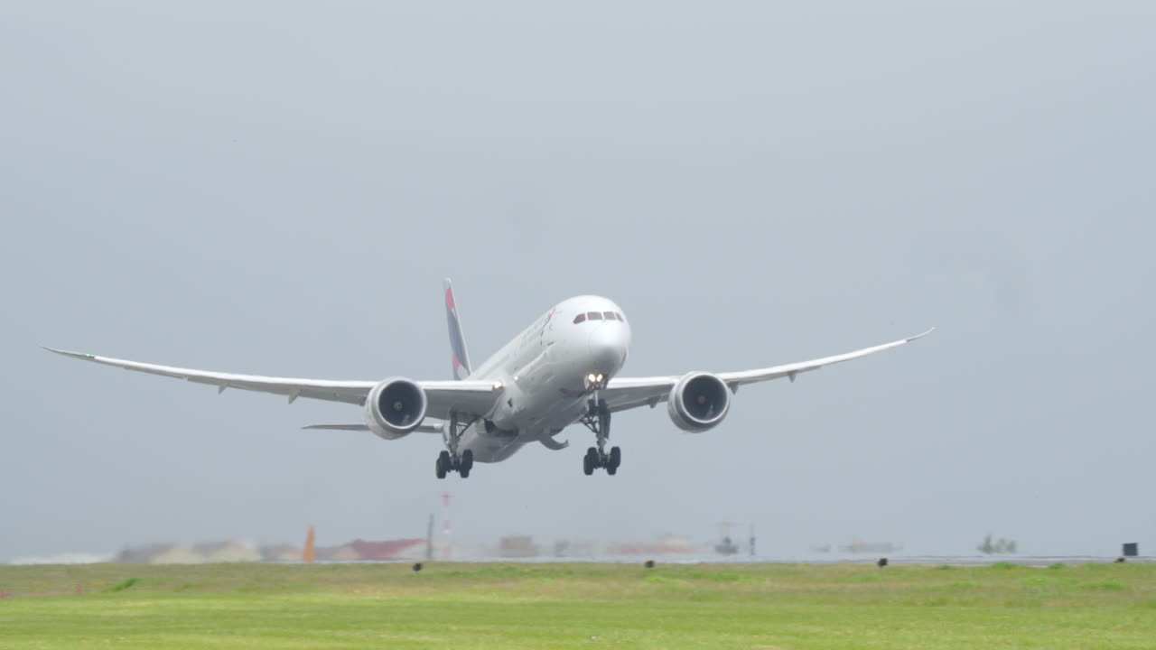 LISBON, PORTUGAL - APRIL 7, 2025: Frontal view of a LATAM Airlines Boeing 787 Dreamliner aircraft taking off from Lisbon Airport. The wide-body jet is seen mid-air with landing gear extended and engines active under cloudy skies