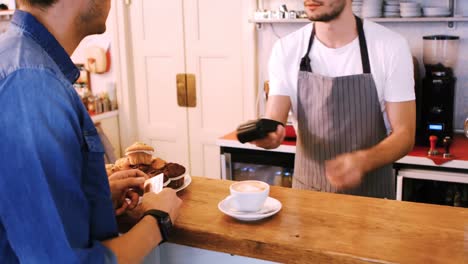 customer making payment through credit card at counter