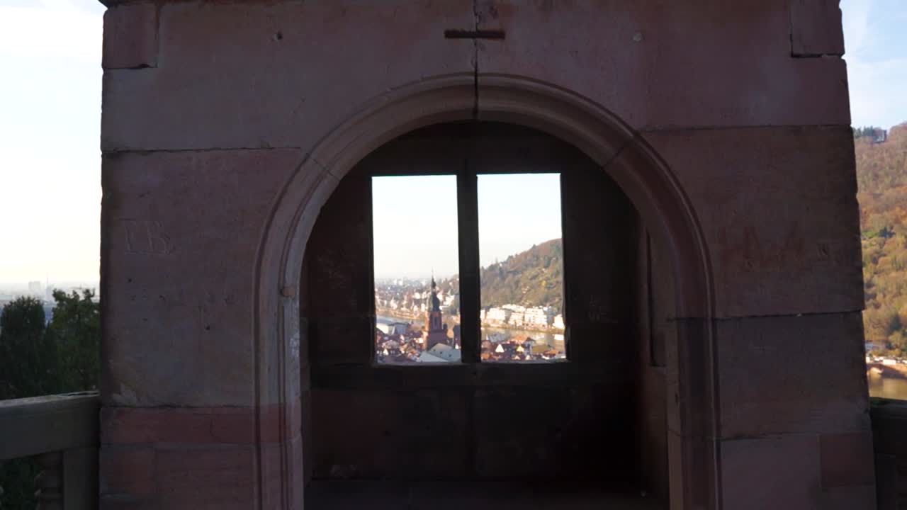 An amazing sunset view through a castle balcony and tower lookout.