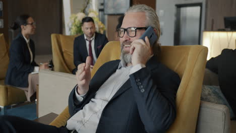 businessman talking on phone in hotel lobby